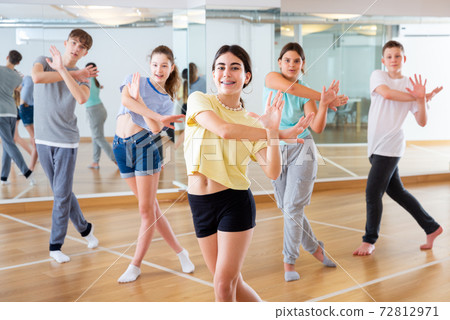 Teenage dancers practicing new dance in studio Teenage dancers practicing new dance in studio 72812971