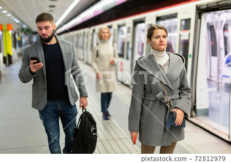 Brunette waiting for train on underground station Brunette waiting for train on underground station 72812979