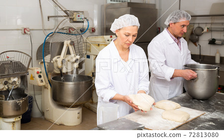 Woman baker forming dough for baking bread Woman baker forming dough for baking bread 72813080
