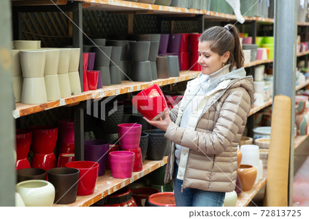 Woman choosing pot for plants 72813725