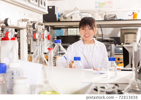 Serious Chinese female student noting results Serious Chinese female student noting results 72813838