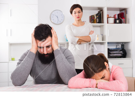 Mother lecturing husband and daughter Mother lecturing husband and daughter 72813864