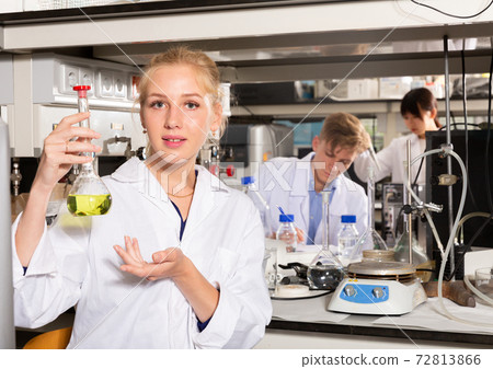 Female student viewing flask of liquor 72813866