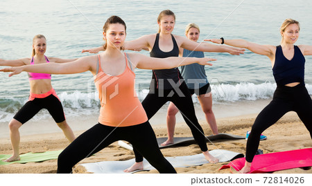 Positive females exercising yoga asanas Positive females exercising yoga asanas 72814026