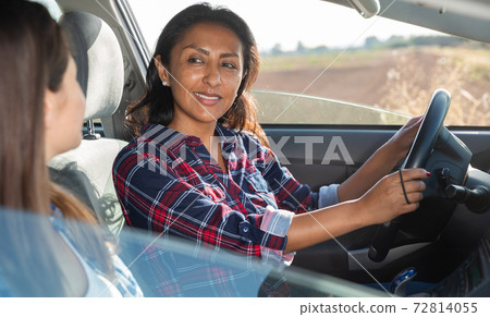 Latino and caucasian women travelling by car Latino and caucasian women travelling by car 72814055
