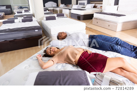 Man and woman choosing mattress in store Man and woman choosing mattress in store 72814289