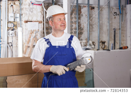 Builder working with angle grinder Builder working with angle grinder 72814353