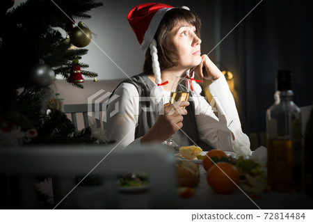 Sad girl celebrates New Year alone 72814484