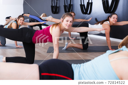 Women practicing yoga at gym Women practicing yoga at gym 72814522