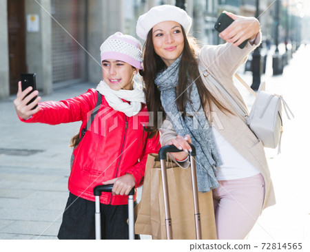 female and child in the center taking selfie female and child in the center taking selfie 72814565