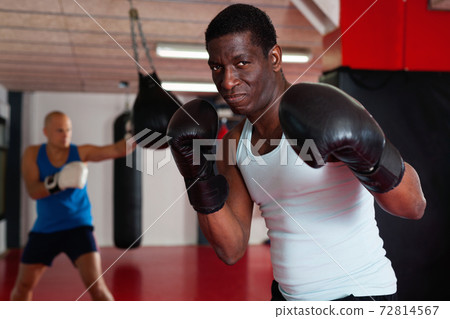 Confident afro american in boxing rack Confident afro american in boxing rack 72814567