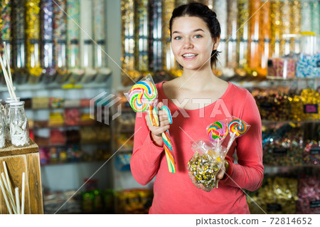 girl buying candies at shop girl buying candies at shop 72814652