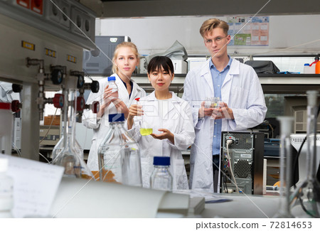 group of scientists posing in modern chemical laboratory 72814653