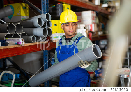 Latin american handyman man choosing building materials in store Latin american handyman man choosing building materials in store 72815090