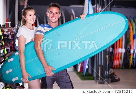 couple is posing in surfboard store on the beach. couple is posing in surfboard store on the beach. 72815215