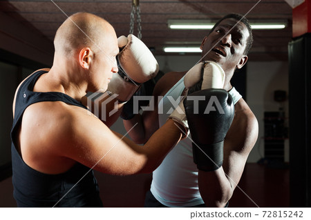 Sparring two boxers in the gym. Battle of two boxers 72815242
