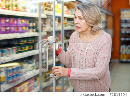 Woman choosing fresh dairy products 72815504