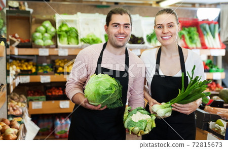 Two sellers offering vegetables Two sellers offering vegetables 72815673