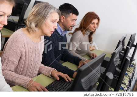 People of different age studying in computer class People of different age studying in computer class 72815791