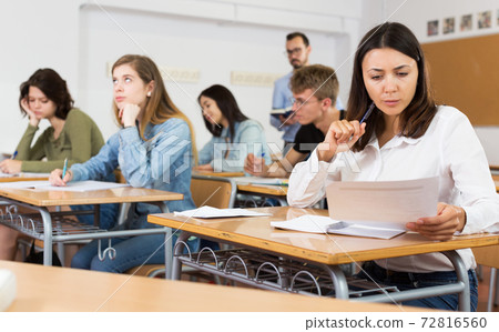 schoolgirl is sitting test and answer about task 72816560