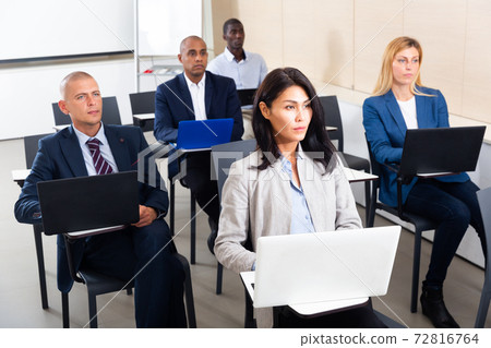 conference of international financial managers with laptop in white room 72816764