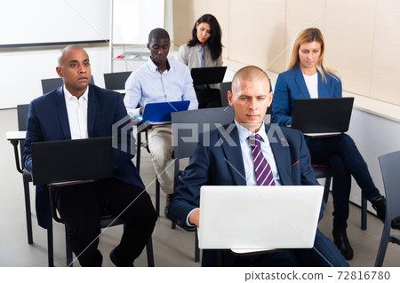 international group of businessmen with computer at world training courses 72816780