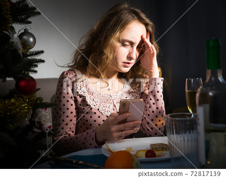 Upset young woman in a quarrel on Christmas night Upset young woman in a quarrel on Christmas night 72817139