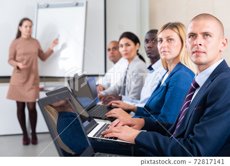 conference of international financial managers with laptop in white room 72817141