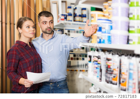 couple is choosing paint with shop list couple is choosing paint with shop list 72817183