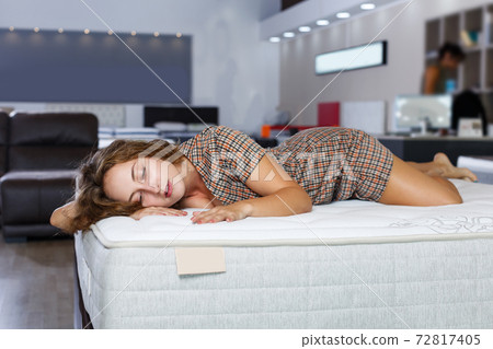 girl testing quality of new mattress 72817405