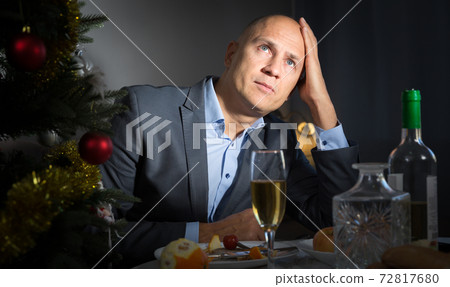 Tired man celebrating New Year 72817680