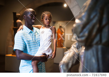 Man and his daughter looking at medieval art Man and his daughter looking at medieval art 72817840