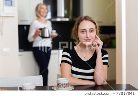 Woman at kitchen table Woman at kitchen table 72817841