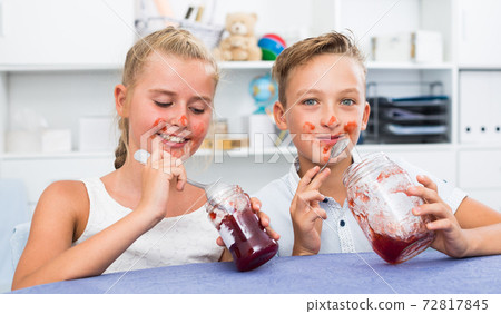 Portrait of sister with brother who are eating jam at time lunch Portrait of sister with brother who are eating jam at time lunch 72817845