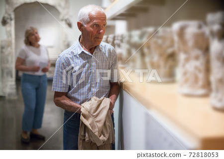 Male visitor looking at exhibit 72818053