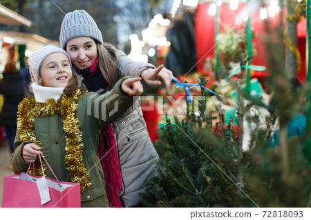 Smiling girl with woman are buying Christmas tree 72818093