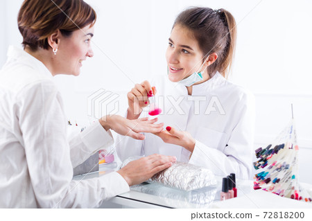 Woman doing manicure Woman doing manicure 72818200