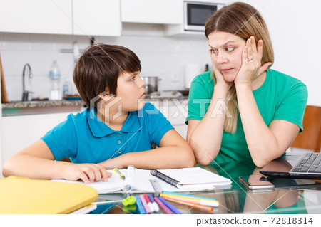 Displeased family doing homework Displeased family doing homework 72818314