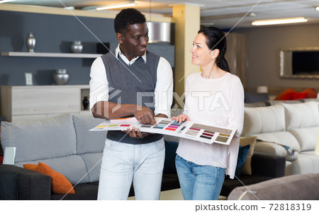 Young couple is choosing colors for furniture Young couple is choosing colors for furniture 72818319