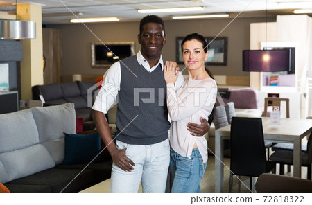 Portrait of smiling couple who is satisfied of choice modern furniture for their home 72818322