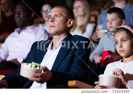 parents with children sitting at movie in cinema parents with children sitting at movie in cinema 72818495