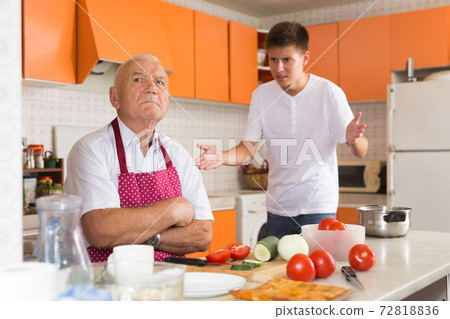 Offended elderly man with disgruntled grandson 72818836