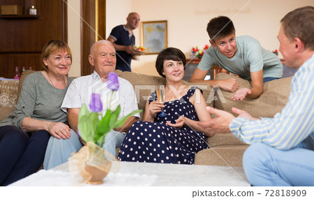 Happy family discussing pleasant topics Happy family discussing pleasant topics 72818909