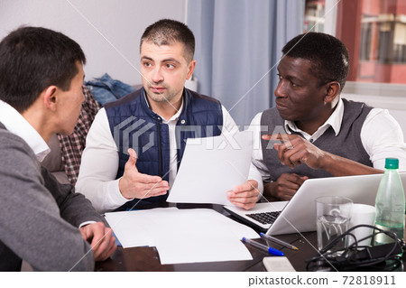 Serious men with documents at home 72818911