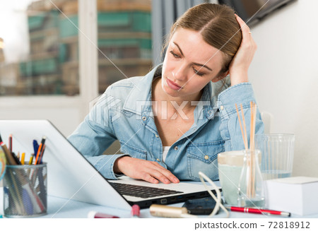 Upset young woman counts family budget on laptop Upset young woman counts family budget on laptop 72818912