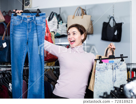 Female 20-29 years old is choosing new jeans Female 20-29 years old is choosing new jeans 72818923