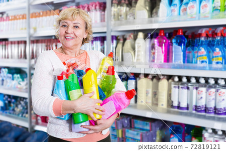 Woman customer holding chemical goods for cleaning Woman customer holding chemical goods for cleaning 72819121