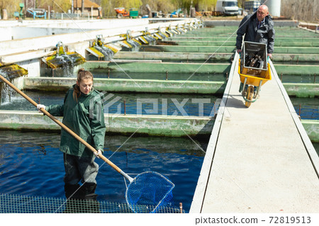 Male and female catching fish from reservoir Male and female catching fish from reservoir 72819513