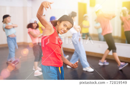Tween african boy hip hop dancer posing during group class Tween african boy hip hop dancer posing during group class 72819549