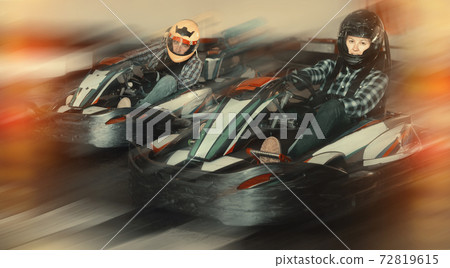 People driving go-kart cars People driving go-kart cars 72819615